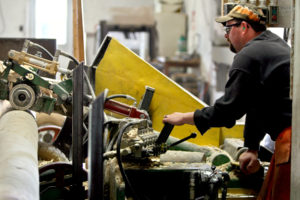 man working on a wood processing machine